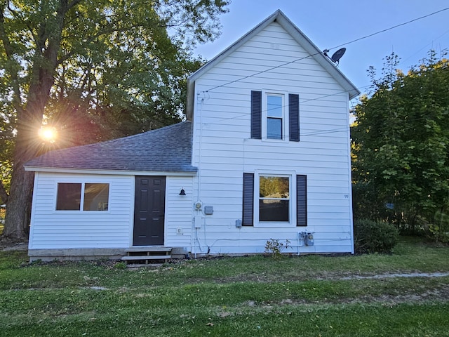 99 S Western Ave, Grant, MI 49327 - view of front of home featuring a shingled roof, entry steps, and a front lawn
