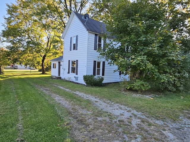 99 S Western Ave, Grant, MI 49327 - view of property exterior with a yard and roof with shingles