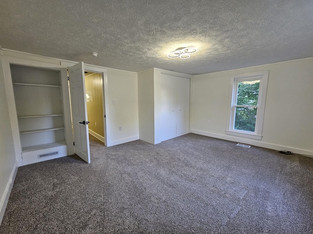 99 S Western Ave, Grant, MI 49327 - unfurnished bedroom featuring a textured ceiling, carpet flooring, baseboards, and a closet