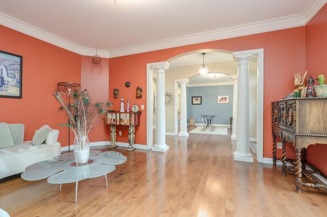 living room featuring ornate columns, hardwood / wood-style floors, and ornamental molding