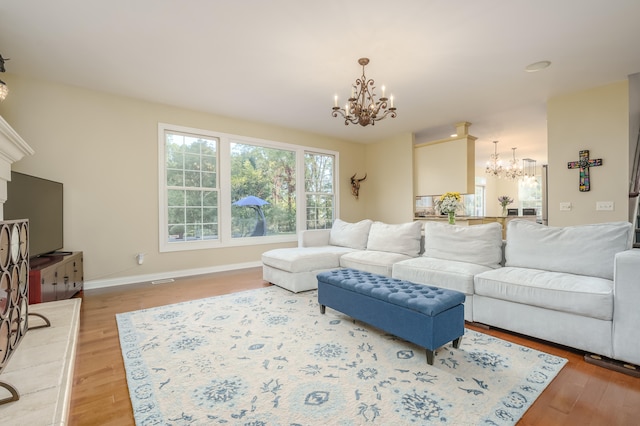 living room featuring hardwood / wood-style floors and a notable chandelier