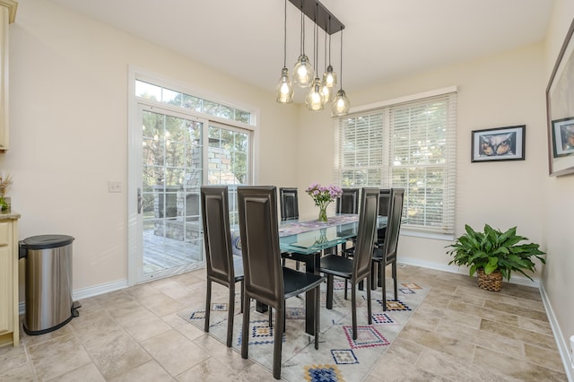 dining area with plenty of natural light and a chandelier