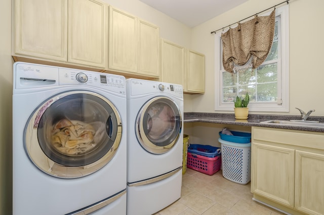 washroom featuring cabinets, separate washer and dryer, sink, and light tile patterned floors