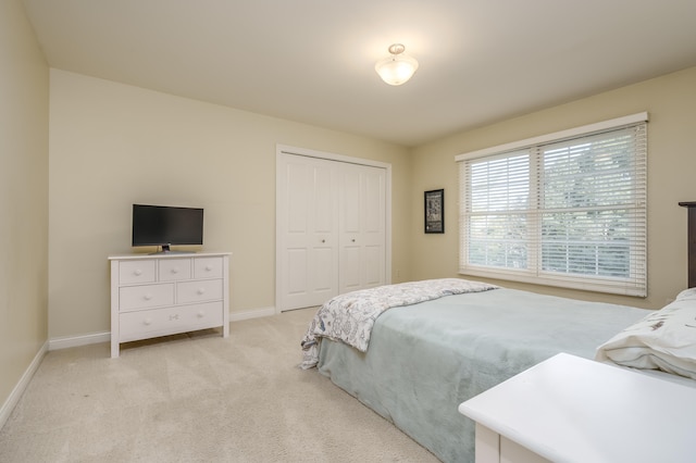 carpeted bedroom with a closet