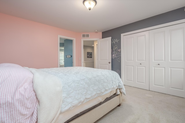 bedroom featuring light colored carpet and a closet