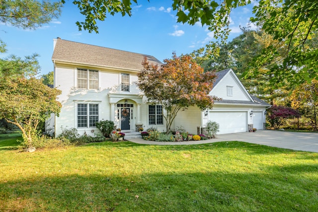 colonial-style house featuring a garage and a front yard