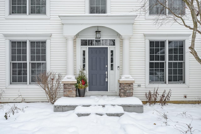 view of snow covered property entrance