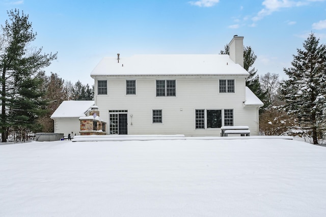 view of snow covered back of property