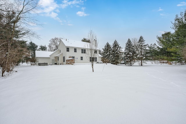 view of snow covered rear of property