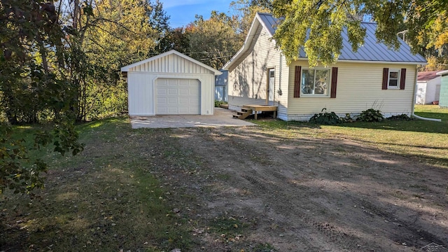 view of front of property featuring an outbuilding, a garage, and a front lawn