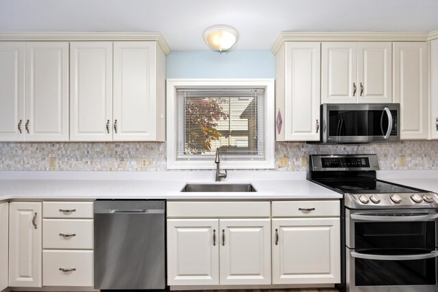 kitchen featuring sink, stainless steel appliances, and tasteful backsplash