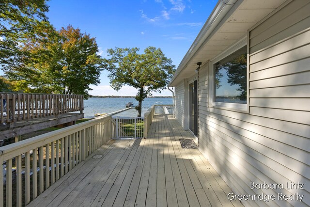 wooden terrace featuring a water view