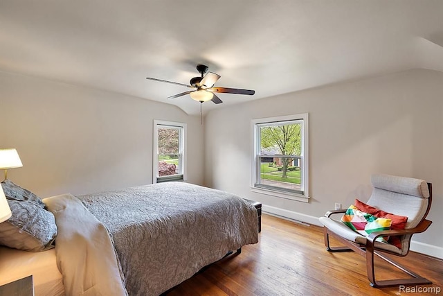 bedroom with ceiling fan, wood-type flooring, and vaulted ceiling