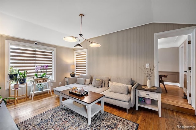 living room featuring hardwood / wood-style flooring and vaulted ceiling