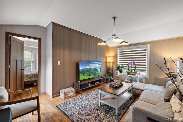 living room featuring hardwood / wood-style flooring and lofted ceiling