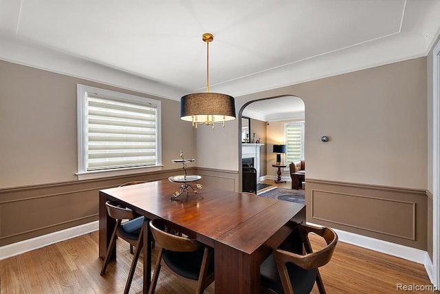 dining area with hardwood / wood-style flooring and ornamental molding