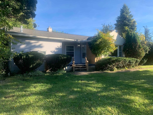 rear view of house with a lawn