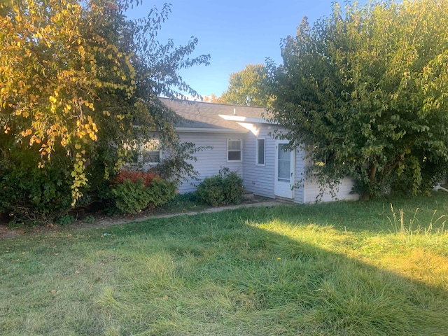 view of home's exterior with a yard