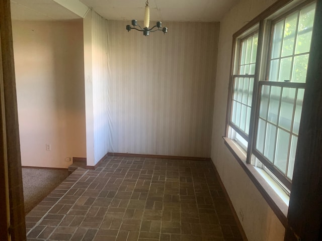 empty room with an inviting chandelier