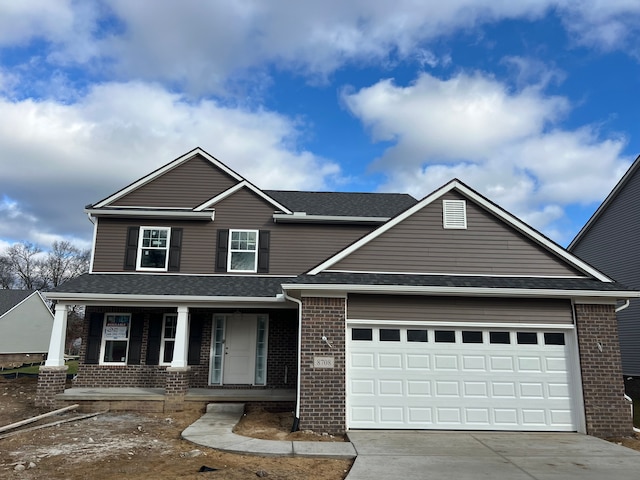 view of front of house featuring a garage and a porch