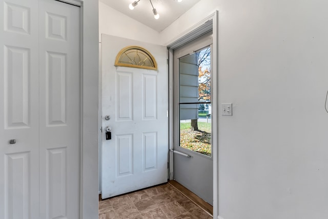 entryway featuring lofted ceiling and a wealth of natural light