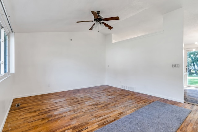 unfurnished room with hardwood / wood-style floors, ceiling fan, and vaulted ceiling