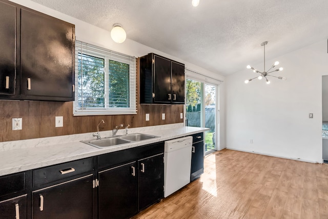 kitchen with dishwasher, a healthy amount of sunlight, decorative light fixtures, and light hardwood / wood-style flooring