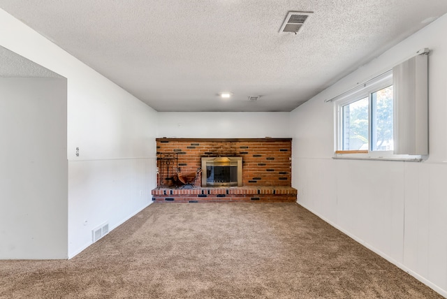 unfurnished living room with carpet flooring and a textured ceiling