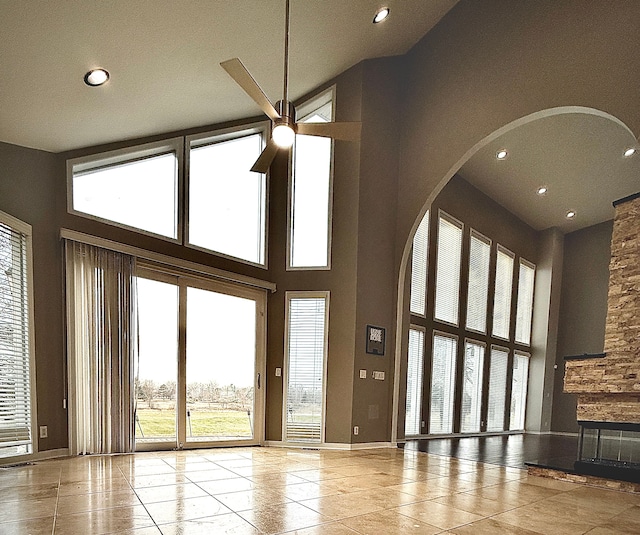 unfurnished living room featuring a high ceiling and light tile patterned flooring