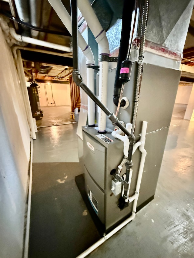 utility room featuring gas water heater