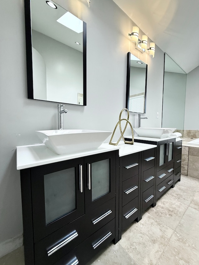 bathroom with vanity and tiled tub