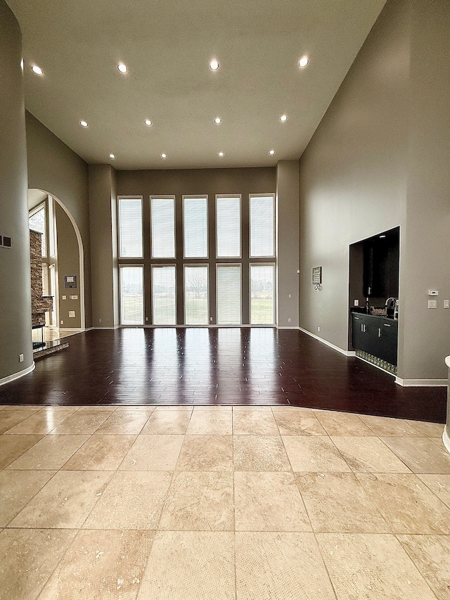 unfurnished living room with a high ceiling