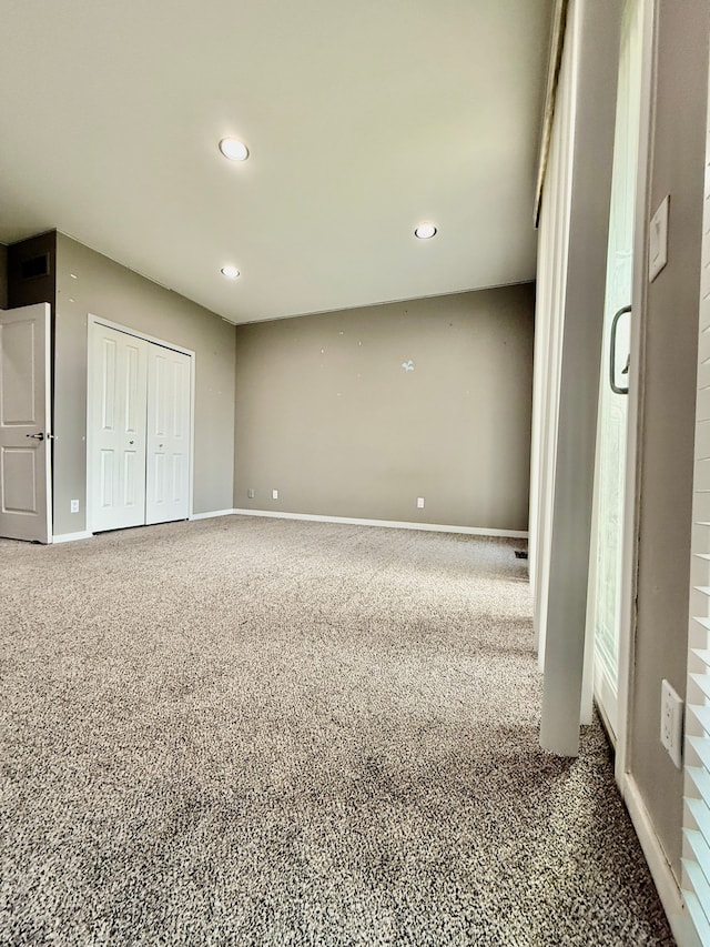 unfurnished bedroom featuring carpet and a closet