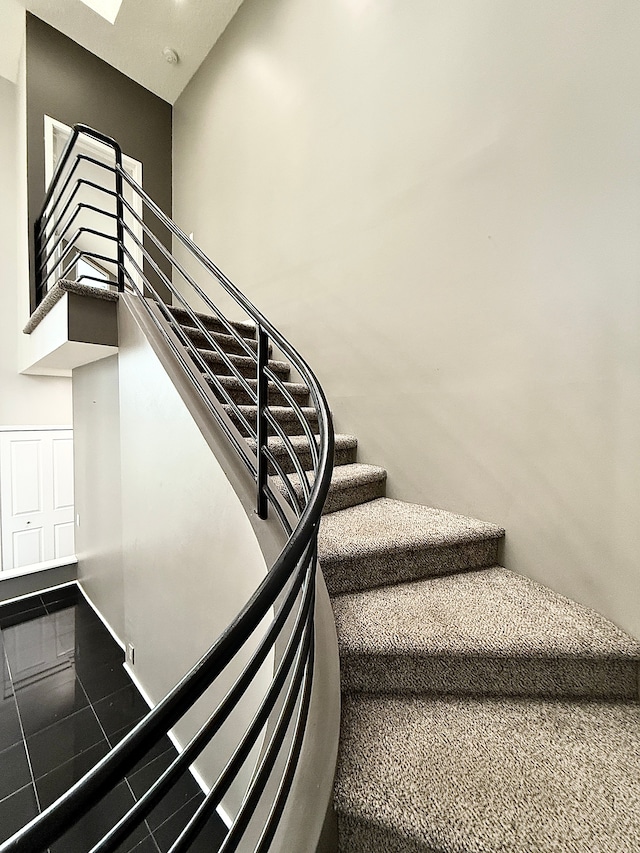 stairway featuring a high ceiling