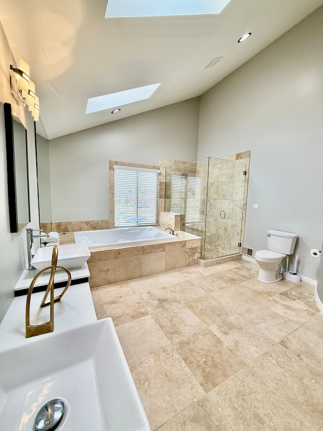 full bathroom with sink, a skylight, high vaulted ceiling, plus walk in shower, and toilet