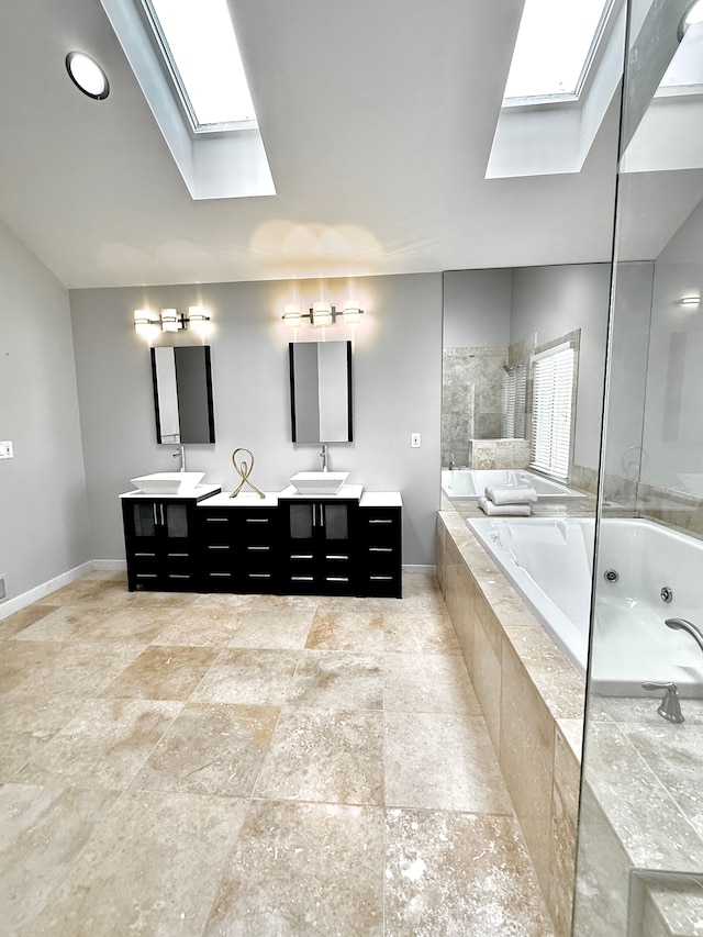 bathroom with vanity, shower with separate bathtub, and a skylight