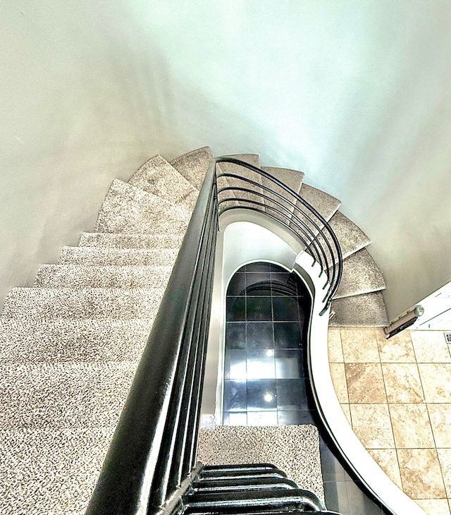 stairs featuring tile patterned flooring