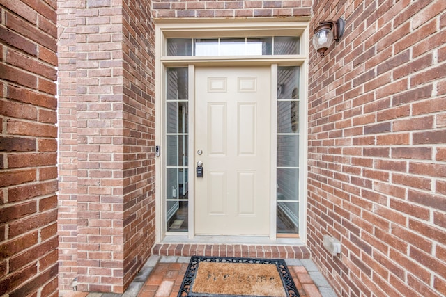 property entrance featuring brick siding