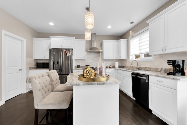 kitchen with a sink, appliances with stainless steel finishes, a center island, wall chimney exhaust hood, and dark wood finished floors