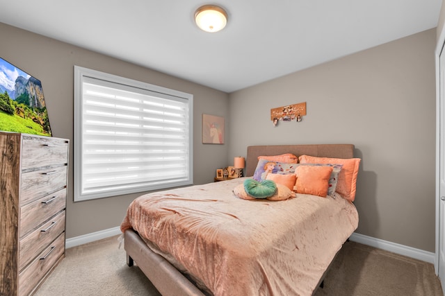 carpeted bedroom with baseboards