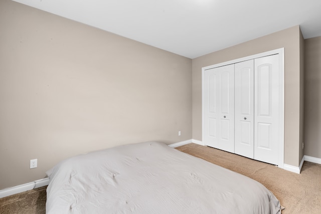 bedroom featuring carpet floors, a closet, and baseboards