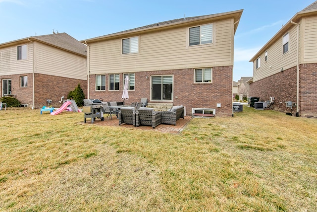 back of house featuring a patio area, outdoor lounge area, a yard, and brick siding