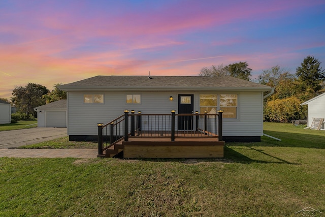 view of front facade with a lawn, a garage, and a deck