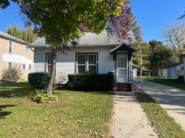 bungalow-style house featuring a front yard