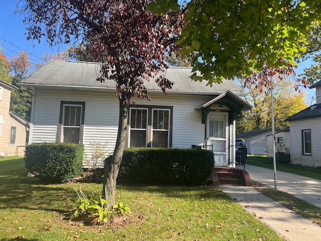 bungalow-style home with a front lawn