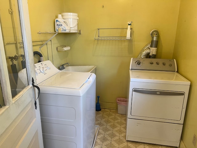 washroom with washing machine and dryer and sink