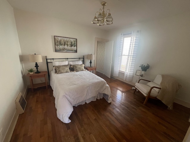 bedroom featuring dark hardwood / wood-style flooring and an inviting chandelier