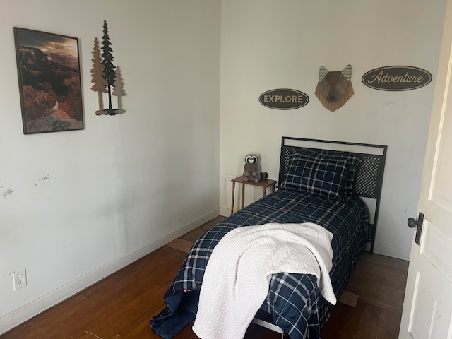 bedroom with dark hardwood / wood-style flooring