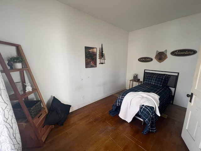 bedroom with dark wood-type flooring