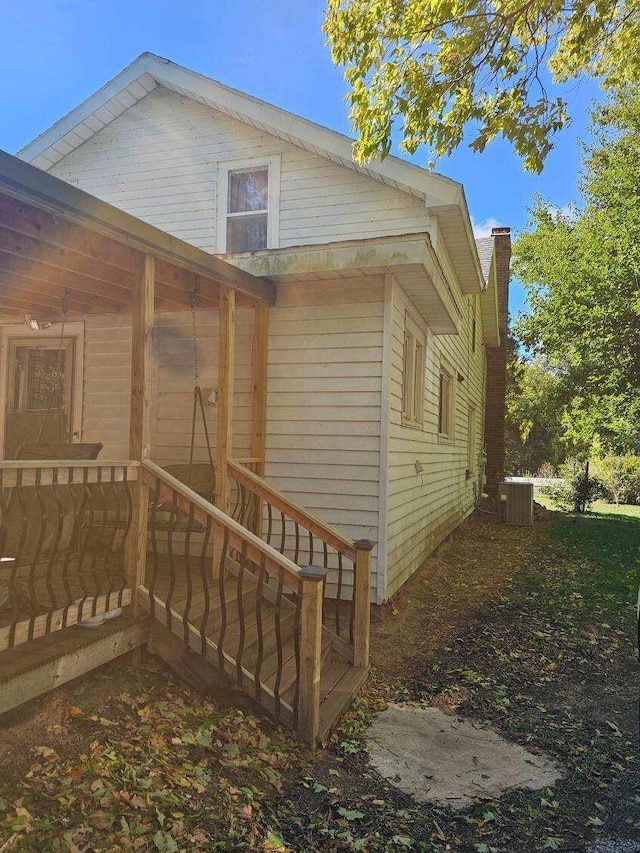 view of side of home with central AC